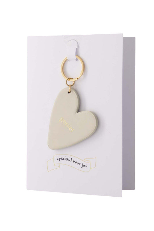 Zusss | Wenskaart sleutelhanger geniet zand